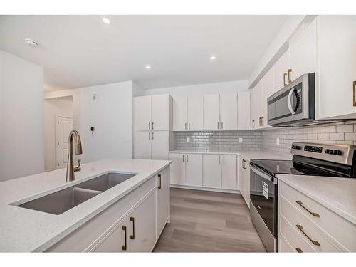 1038 Thimbleberry Hill Sw, Airdrie, AB - Indoor Photo Showing Kitchen With Double Sink With Upgraded Kitchen