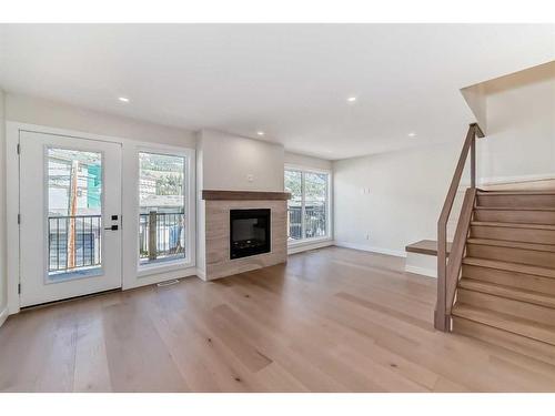 115-1330 1St Ave, Canmore, AB - Indoor Photo Showing Living Room With Fireplace