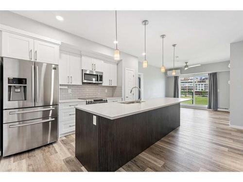 308-4150 Seton Drive Se, Calgary, AB - Indoor Photo Showing Kitchen With Stainless Steel Kitchen With Upgraded Kitchen