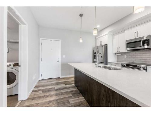 308-4150 Seton Drive Se, Calgary, AB - Indoor Photo Showing Kitchen With Double Sink With Upgraded Kitchen