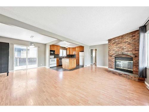 47 Queen Isabella Close Se, Calgary, AB - Indoor Photo Showing Living Room With Fireplace