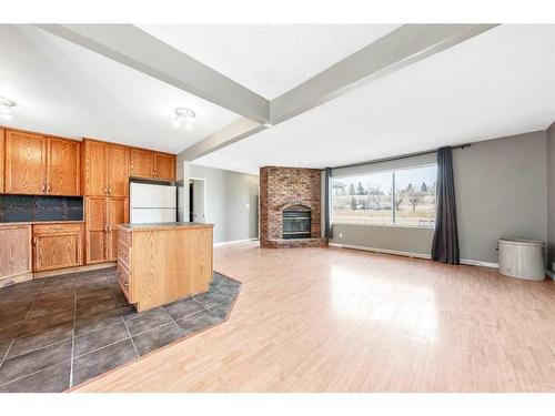 47 Queen Isabella Close Se, Calgary, AB - Indoor With Fireplace