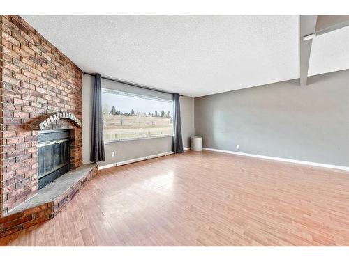 47 Queen Isabella Close Se, Calgary, AB - Indoor With Fireplace