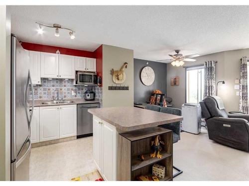 410-6000 Somervale Court Sw, Calgary, AB - Indoor Photo Showing Kitchen With Double Sink