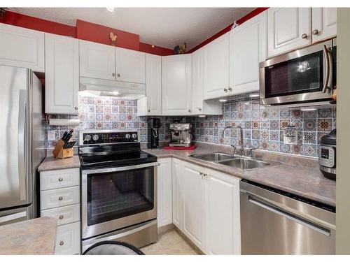 410-6000 Somervale Court Sw, Calgary, AB - Indoor Photo Showing Kitchen With Double Sink