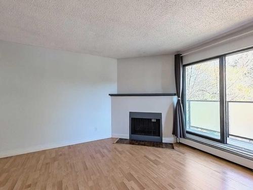 202-1821 17A Street Sw, Calgary, AB - Indoor Photo Showing Living Room With Fireplace