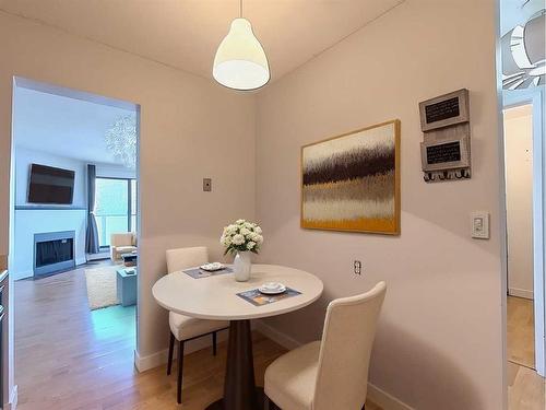 202-1821 17A Street Sw, Calgary, AB - Indoor Photo Showing Dining Room With Fireplace