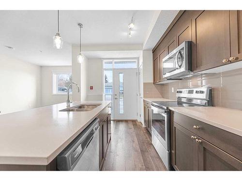 16-30 Shawnee Common Sw, Calgary, AB - Indoor Photo Showing Kitchen With Double Sink With Upgraded Kitchen