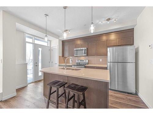 16-30 Shawnee Common Sw, Calgary, AB - Indoor Photo Showing Kitchen With Double Sink With Upgraded Kitchen