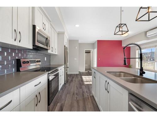 101-360 Harvest Hills Common Ne, Calgary, AB - Indoor Photo Showing Kitchen With Stainless Steel Kitchen With Double Sink With Upgraded Kitchen