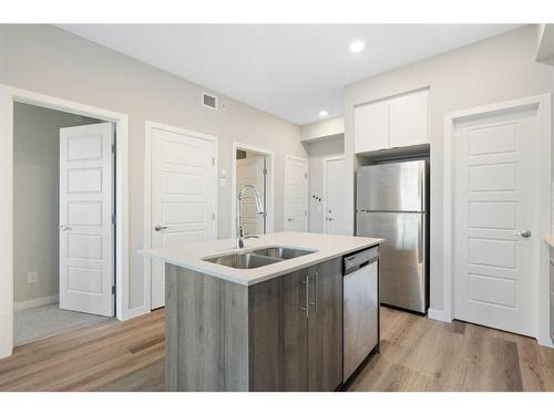 320-1605 17 Street Se, Calgary, AB - Indoor Photo Showing Kitchen With Stainless Steel Kitchen With Double Sink