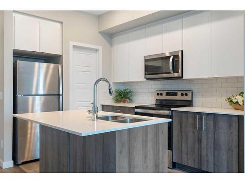 320-1605 17 Street Se, Calgary, AB - Indoor Photo Showing Kitchen With Stainless Steel Kitchen With Double Sink With Upgraded Kitchen