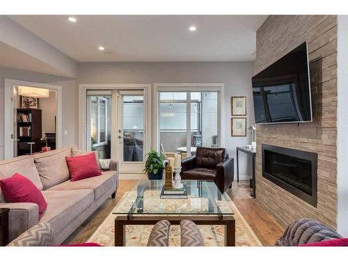 4-2432 30 Street Sw, Calgary, AB - Indoor Photo Showing Living Room With Fireplace