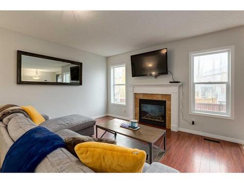 1019 Windhaven Close Sw, Airdrie, AB - Indoor Photo Showing Living Room With Fireplace