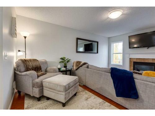 1019 Windhaven Close Sw, Airdrie, AB - Indoor Photo Showing Living Room With Fireplace