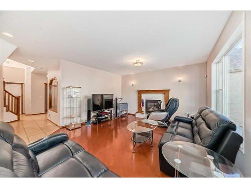 180 Panatella Close Nw, Calgary, AB - Indoor Photo Showing Living Room With Fireplace