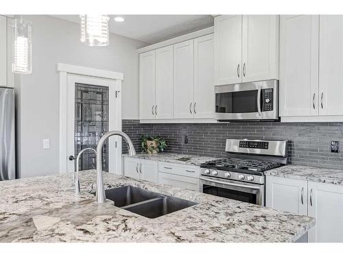 245 Riverwood Crescent Sw, Diamond Valley, AB - Indoor Photo Showing Kitchen With Double Sink With Upgraded Kitchen