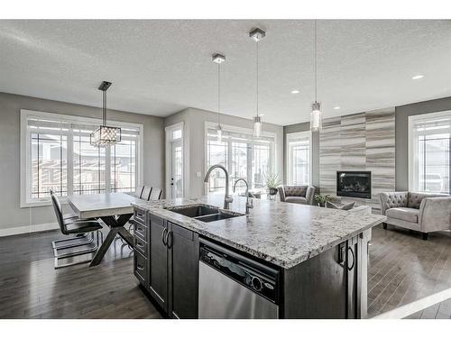 245 Riverwood Crescent Sw, Diamond Valley, AB - Indoor Photo Showing Kitchen With Fireplace With Double Sink With Upgraded Kitchen