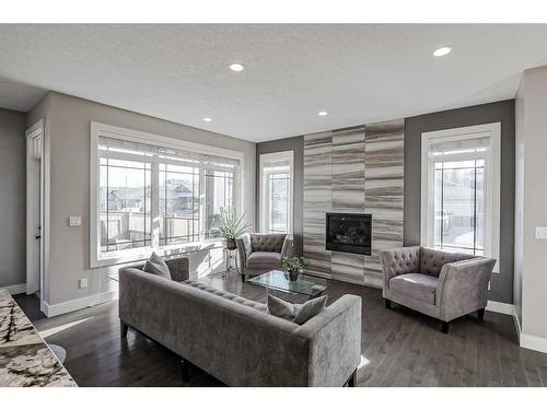 245 Riverwood Crescent Sw, Diamond Valley, AB - Indoor Photo Showing Living Room With Fireplace