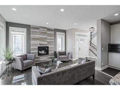 245 Riverwood Crescent Sw, Diamond Valley, AB - Indoor Photo Showing Living Room With Fireplace