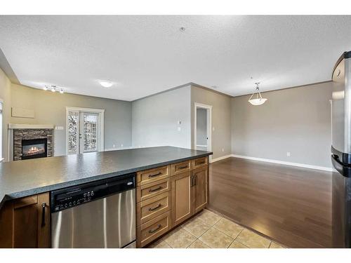 504-20 Discovery Ridge Close Sw, Calgary, AB - Indoor Photo Showing Kitchen With Fireplace