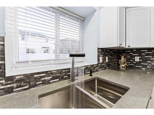 250 Luxstone Road Sw, Airdrie, AB - Indoor Photo Showing Kitchen With Double Sink