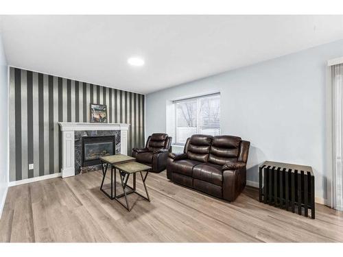 250 Luxstone Road Sw, Airdrie, AB - Indoor Photo Showing Living Room With Fireplace