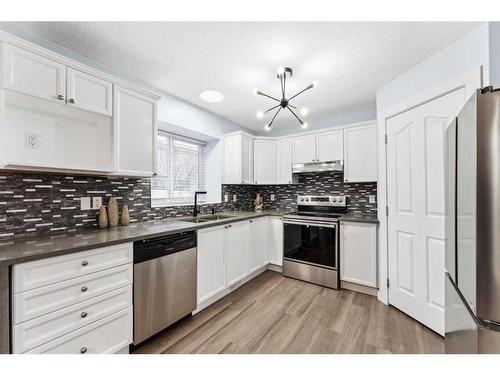 250 Luxstone Road Sw, Airdrie, AB - Indoor Photo Showing Kitchen With Stainless Steel Kitchen With Double Sink With Upgraded Kitchen