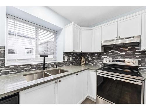 250 Luxstone Road Sw, Airdrie, AB - Indoor Photo Showing Kitchen With Double Sink With Upgraded Kitchen