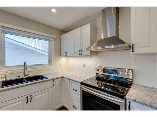 80 Woodglen Close Sw, Calgary, AB - Indoor Photo Showing Kitchen With Stainless Steel Kitchen With Double Sink With Upgraded Kitchen