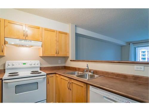 4204-10 Prestwick Bay Se, Calgary, AB - Indoor Photo Showing Kitchen With Double Sink