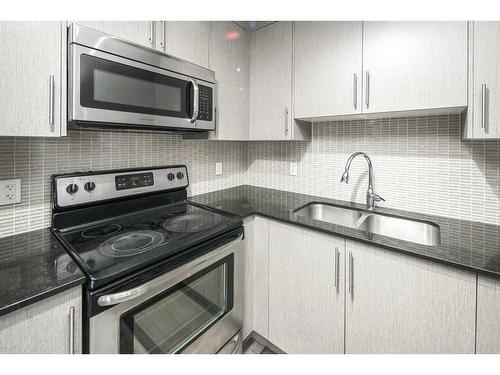 6-35 West Coach Manor Sw, Calgary, AB - Indoor Photo Showing Kitchen With Double Sink With Upgraded Kitchen