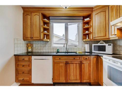 940 Rundlecairn Way Ne, Calgary, AB - Indoor Photo Showing Kitchen With Double Sink