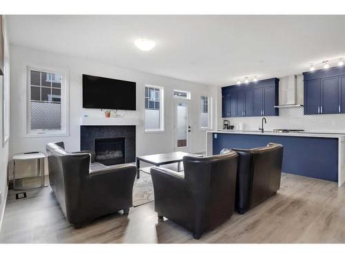 901 Windsong Drive Sw, Airdrie, AB - Indoor Photo Showing Living Room With Fireplace