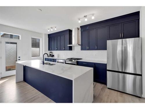 901 Windsong Drive Sw, Airdrie, AB - Indoor Photo Showing Kitchen With Stainless Steel Kitchen With Double Sink With Upgraded Kitchen