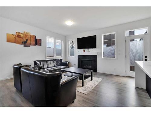 901 Windsong Drive Sw, Airdrie, AB - Indoor Photo Showing Living Room With Fireplace