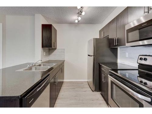 1335-81 Legacy Boulevard Se, Calgary, AB - Indoor Photo Showing Kitchen With Stainless Steel Kitchen With Double Sink