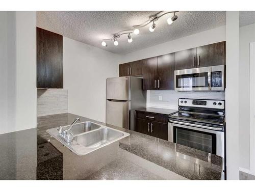 1335-81 Legacy Boulevard Se, Calgary, AB - Indoor Photo Showing Kitchen With Stainless Steel Kitchen With Double Sink