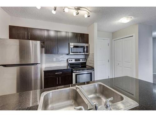 1335-81 Legacy Boulevard Se, Calgary, AB - Indoor Photo Showing Kitchen With Stainless Steel Kitchen With Double Sink