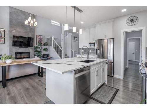 132 Sunrise Common, Cochrane, AB - Indoor Photo Showing Kitchen With Fireplace With Upgraded Kitchen