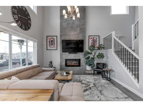 132 Sunrise Common, Cochrane, AB - Indoor Photo Showing Living Room With Fireplace