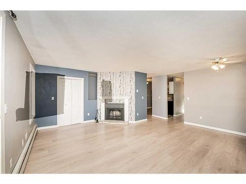 105-219 Huntington Park Bay Nw, Calgary, AB - Indoor Photo Showing Living Room With Fireplace