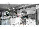 303-70 Saddlestone Drive Ne, Calgary, AB  - Indoor Photo Showing Kitchen With Stainless Steel Kitchen With Double Sink With Upgraded Kitchen 