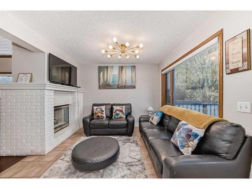 103 Hawktree Close Nw, Calgary, AB - Indoor Photo Showing Living Room With Fireplace