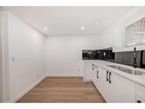 128 Cantrell Place Sw, Calgary, AB - Indoor Photo Showing Kitchen With Double Sink