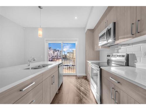 450 Canals Crossing Sw, Airdrie, AB - Indoor Photo Showing Kitchen With Double Sink