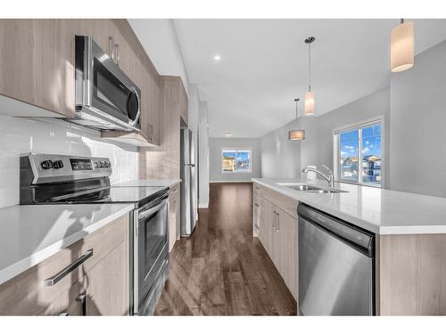 450 Canals Crossing Sw, Airdrie, AB - Indoor Photo Showing Kitchen With Double Sink With Upgraded Kitchen