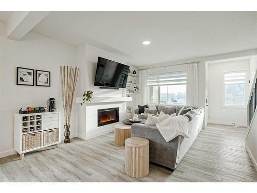 255 Creekstone Way Sw, Calgary, AB - Indoor Photo Showing Living Room With Fireplace