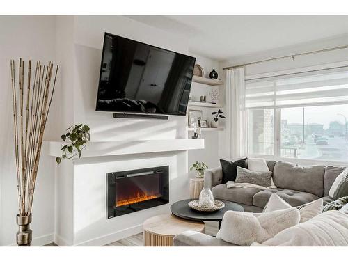 255 Creekstone Way Sw, Calgary, AB - Indoor Photo Showing Living Room With Fireplace