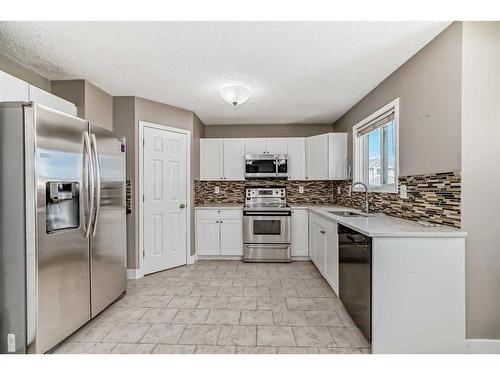 27 Canoe Circle Sw, Airdrie, AB - Indoor Photo Showing Kitchen With Upgraded Kitchen